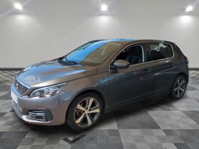 a grey car is parked in a room with a checkered floor