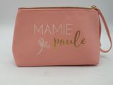 a close up of a pink purse with gold lettering on it
