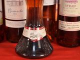 several bottles of wine are lined up on a red table cloth