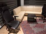 a living room with a couch, chair, coffee table and rug