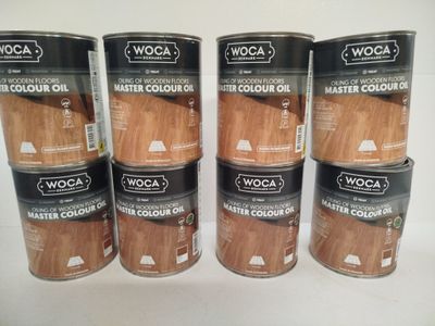 a group of four cans of wood stain on a white surface