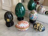 many decorative eggs sitting on a marble counter top