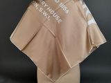 a brown umbrella with white writing on it on a mannequin head