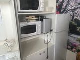 a microwave and a refrigerator in a small room