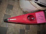 a red kayak that is sitting on the floor