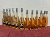 six bottles of wine are lined up in a row on a table