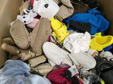 a cardboard box filled with lots of clothes and shoes