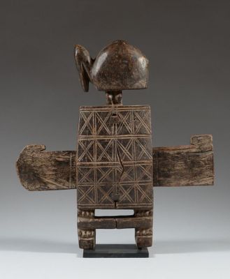 a wooden sculpture of a bird sitting on top of a piece of wood