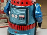 a toy robot that is sitting next to a box