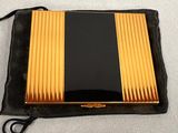 a black and gold case sitting on top of a black bag