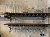many empty wine glasses on the shelves in the kitchen