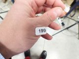 a person holding a piece of paper with the number 19 on it