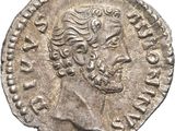 a silver coin with an image of a man on it