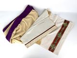 three pieces of clothing are laying on a white surface