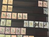 a lot of stamps on a table with a black background
