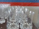 many glasses on a table with a blue and red stripe