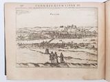 an open book with a drawing of a town in the background