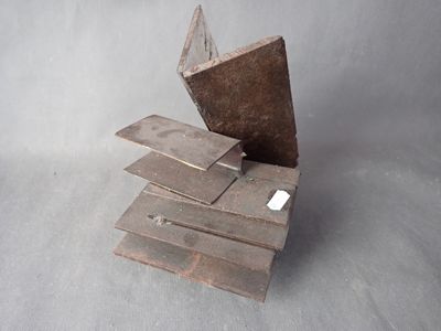several pieces of wood are stacked on top of each other on a gray surface