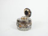 a small glass jar with a lid on a white surface