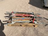 a pile of tools on a pallet in the dirt
