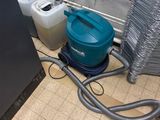 a picture of a room that has a vacuum and other items on the floor