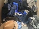 a box full of clothes and a hat in it
