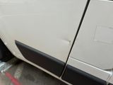 a white van that is parked on the side of the street