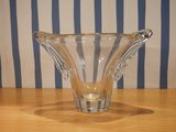 a clear glass vase sitting on a wooden table