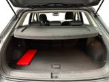 the back of a car with the trunk open and a red mat in the trunk