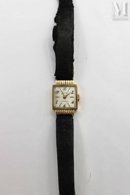 a close up of a wrist watch on a white surface