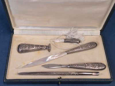 three knives and a knife sharper in a case