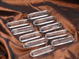 six clear glass tubes sitting on top of a brown cloth