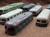 several toy trains are lined up in a row on a table