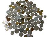 a pile of coins sitting on top of a white surface