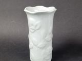 a white vase that is sitting on a table