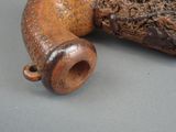 an old wooden pipe with a handle on a table