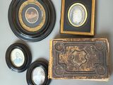 three framed pictures on the wall next to a wooden box