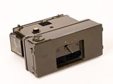an old camera that is sitting on a white surface
