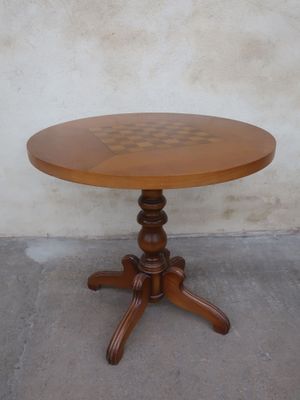 a small table with a wooden top on a concrete floor