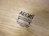 a close up of a woodworking logo on a piece of wood