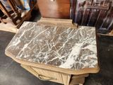 a marble top table on wheels in a room