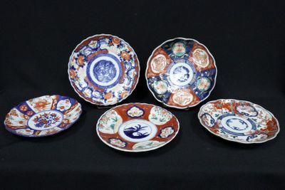 six plates with different designs on them sitting on a black surface