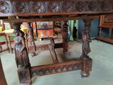 a wooden table with carvings on it in a room