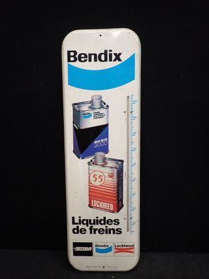 une photo d'une boîte de liquide Bendix accompagnée d'un thermomètre