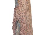 a figurine of a woman standing on a white surface