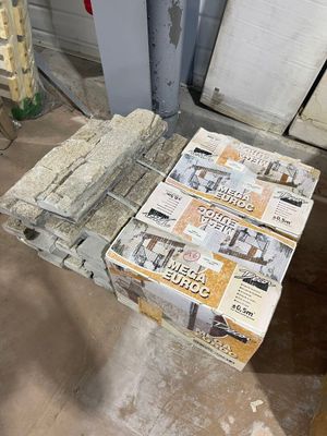 a stack of newspapers sitting on top of a wooden table