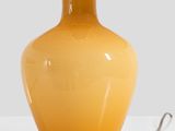 a yellow lamp that is sitting on a table