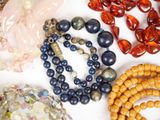 many different colored beads and bracelets on a table