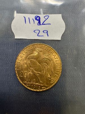 a close up of a gold coin with a label on it
