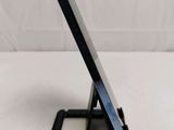 a close up of a cell phone on a stand on a table